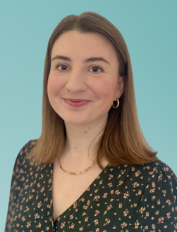 Portrait photograph of Miriam Scott-Pearce against a pale turquoise background