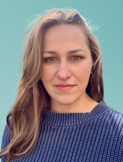 Portrait photo of Emma Beamish Senior Evaluation Consultant at Matter of Focus. Emma has long light-brown hair and is wearing a blue knit sweater. The background is plain teal.
